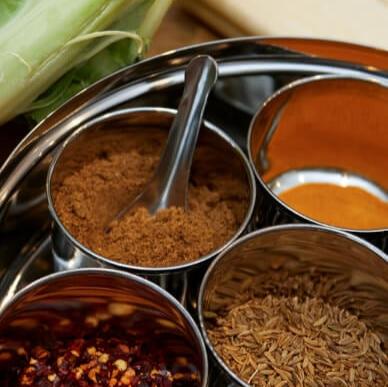 Spices and curry base ingredients at Emerge Cookery School.